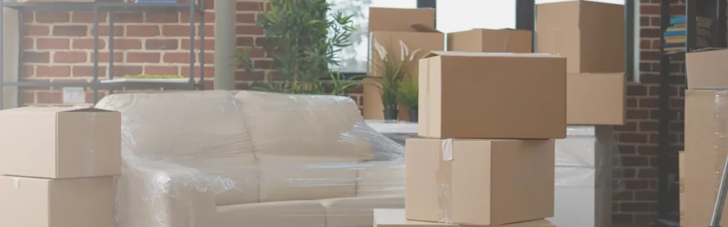 Packed moving boxes and wrapped furniture ready for secure storage in Basingstoke